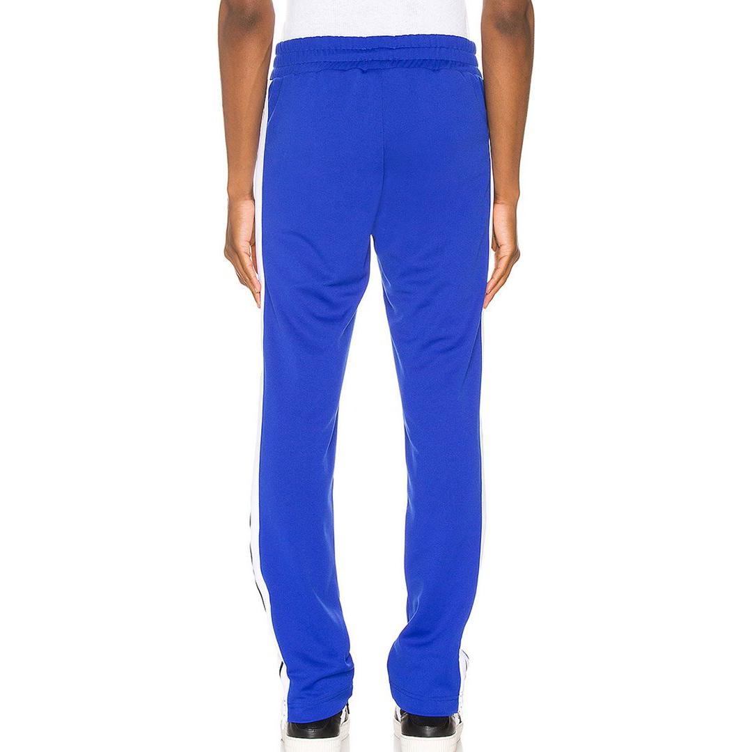 PALM ANGELS TAPED TRACK PANTS IN BLUE/WHITE