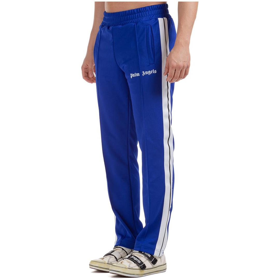 PALM ANGELS TAPED TRACK PANTS IN BLUE/WHITE